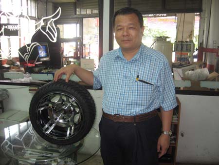 Johnsun Chiang, chairman of Rolling Tech, and his company`s latest high-level rim model.
