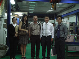 Neotronics management poses with overseas clients.