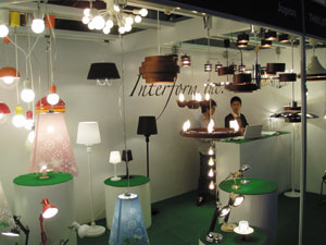 Interform promotes household lights with laser-cut motifs on lampshades and wooden lamp bases.