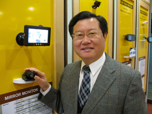 Kim Tsai, Mobiletron`s chairman, demonstrates his company`s latest night-vision system.