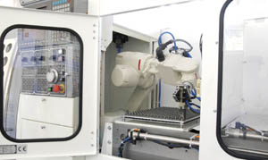 The robotic arm attached to this CNC lath is an innovation by Quick-Tech.