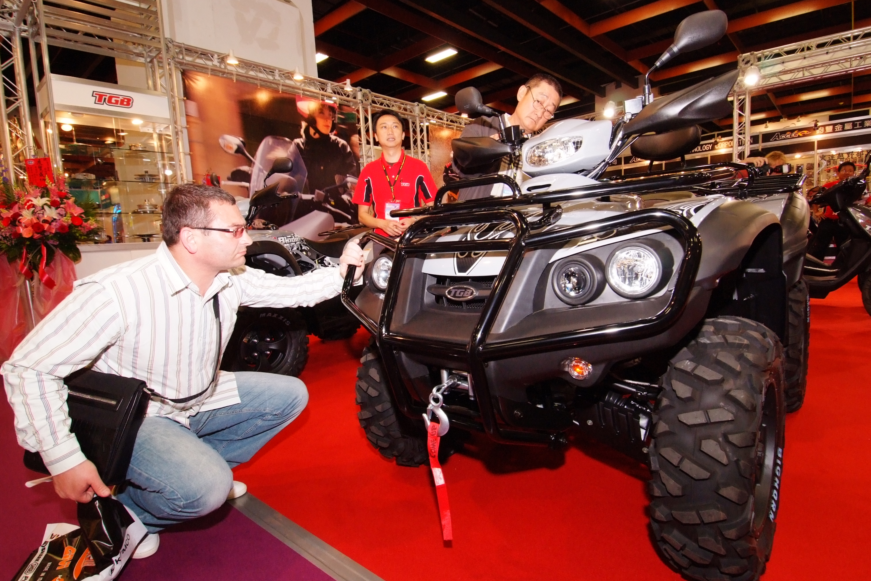 International buyers carefully look over high-quality powersports products made by local companies.