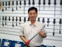 William Chiang, chairman of William Tools, shows the newest Screen Torque Wrench.