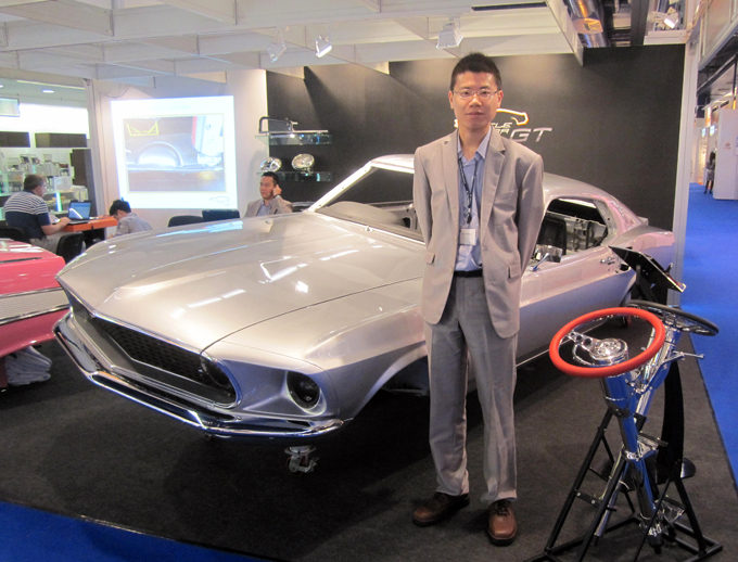Howard Lin, sales manager of Muscle Car GT, and the body of a 1969 Ford Mustang replica made by his company.