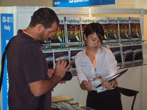 CENS representative (right) helps out a foreign buyer at HK Lighting Fair.