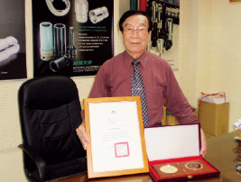 M.C. Cheng, chairman of Taiwan Hand Tool Manufacturers` Association, shows commendations from Chinese National Federation of Industries and Ministry of Interior for contributions to development of Taiwanese hand tool industry.