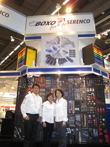 Jessy Chang, marketing manger of Machan, and senior company officials stand in front of the BOXO tool displaying wall.