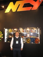 Chen Chung-jung, president of NCY, and his company's high-end PTW tuning parts.