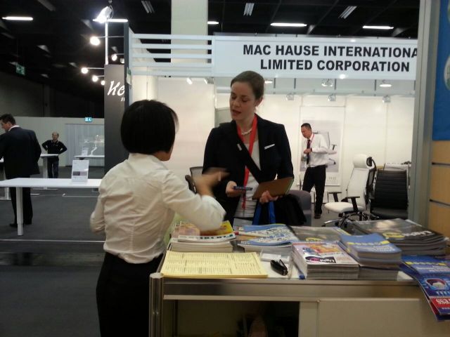 CENS representative (back to camera) helps a buyer at Orgatec.