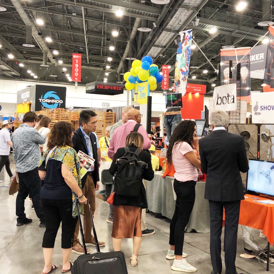 Buyers and exhibitors interact at the NHS show. Photo credit: CENS