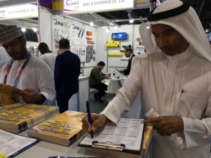 A buyer attentively filled out CENS' business matchmaking form at Automechanika Dubai 2022. (Photo courtesy of CENS)